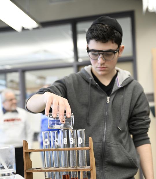 Teen working with beakers
